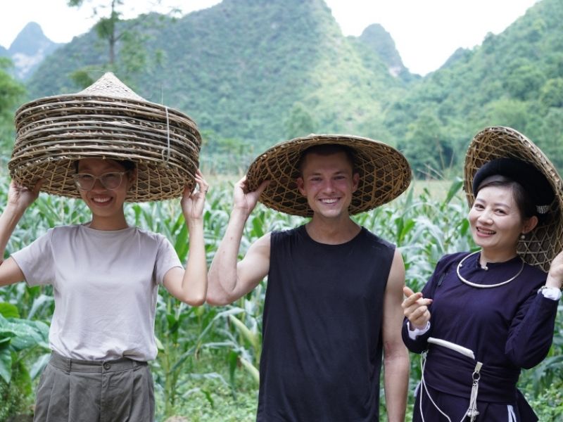 Tourists experience wearing conical hats.